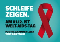 Eine Aids-Schleife und die Aufforderung "Schleife zeigen" weist auf den Welt-Aids-Tag am 1. Dezember hin